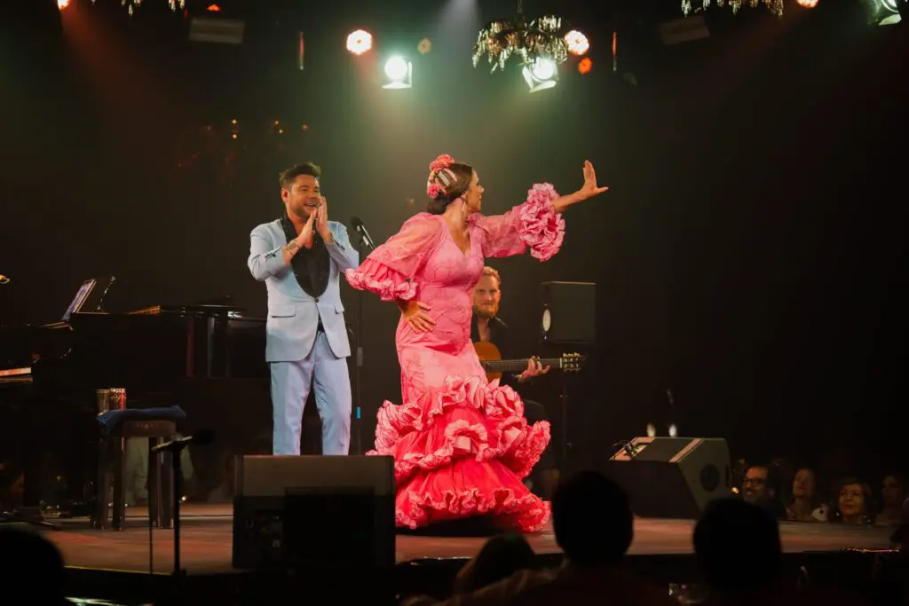 Performers dancing and singing on stage at Alma Casa de Campo