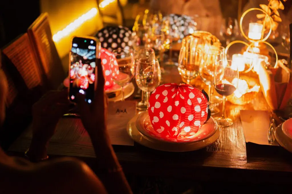 A guest taking a photo of the table setting at Alma Casa de Campo
