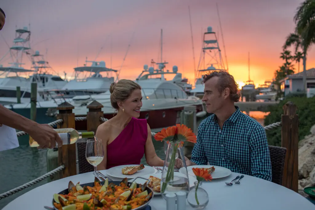 A couple enjoying fine dining outdoors at La Casita