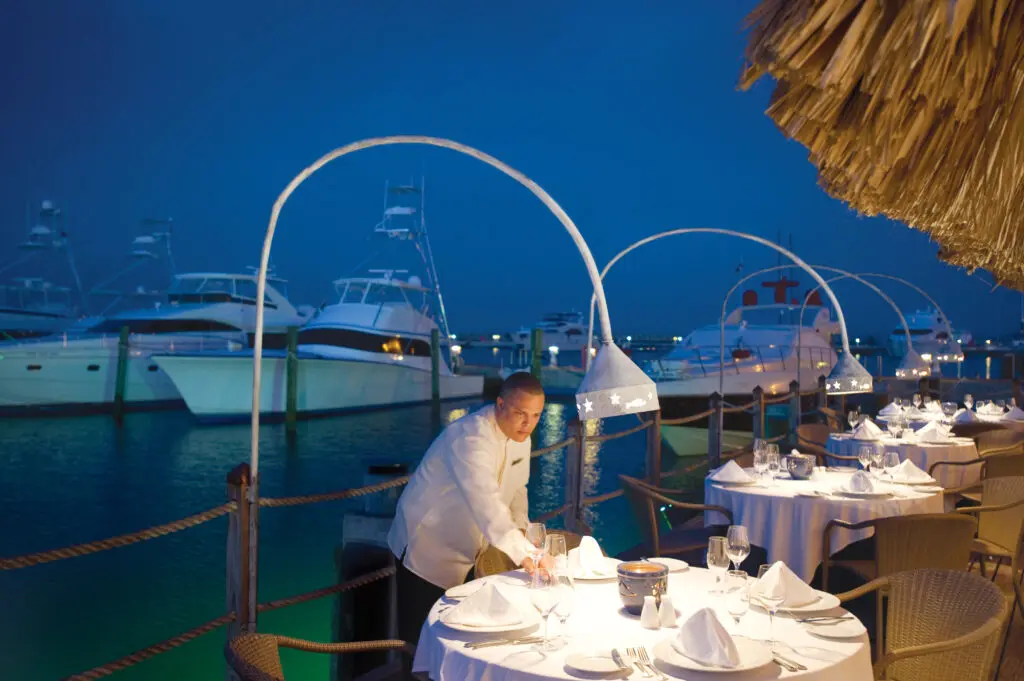A nighttime view of fine dining tables near the Marina at La Casita