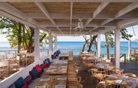 Colorful seating area with an ocean view at our beachfront restaurant