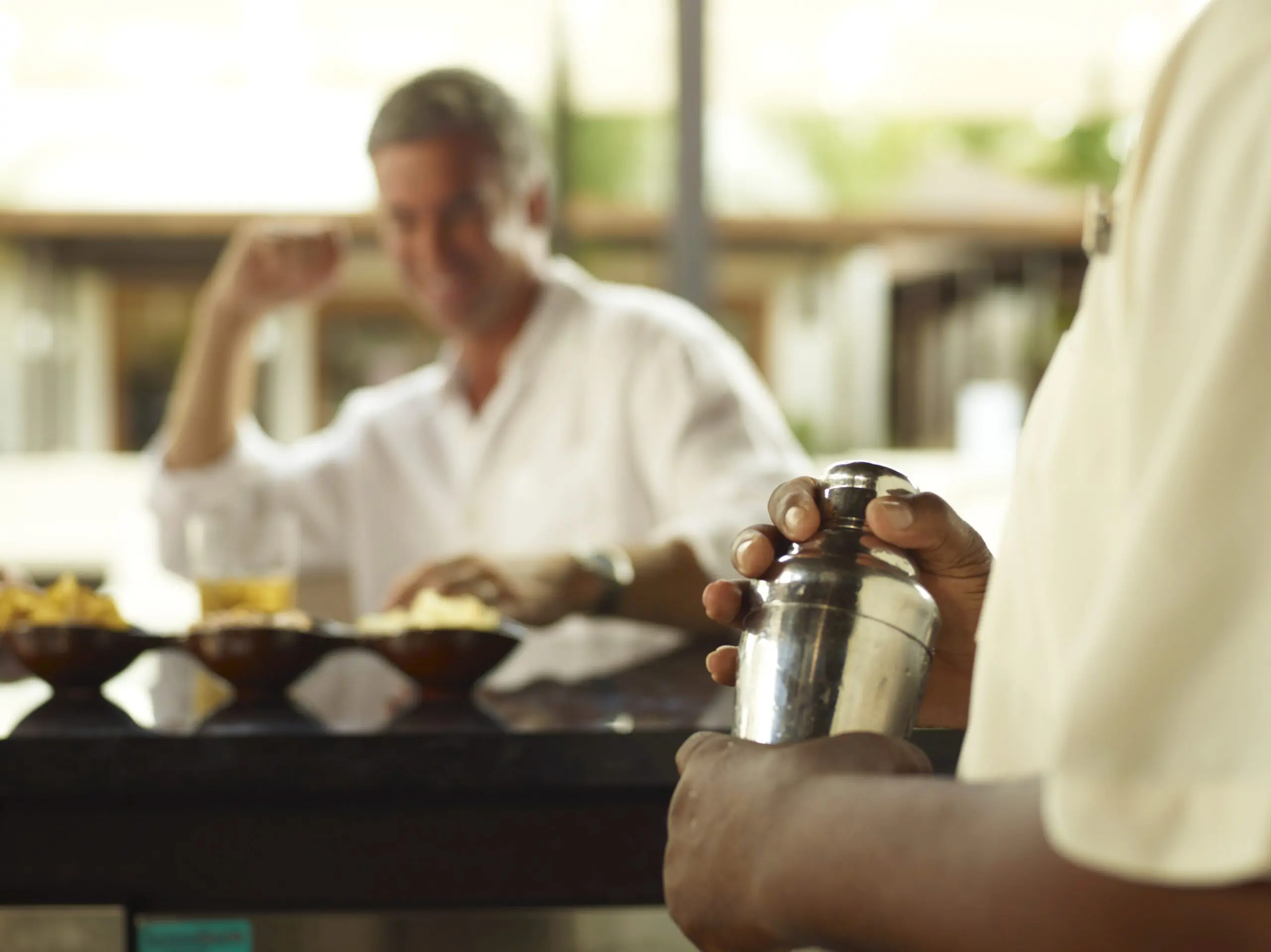 Bartender preparing drinks for guests at La Caña Bar &amp; Restaurant