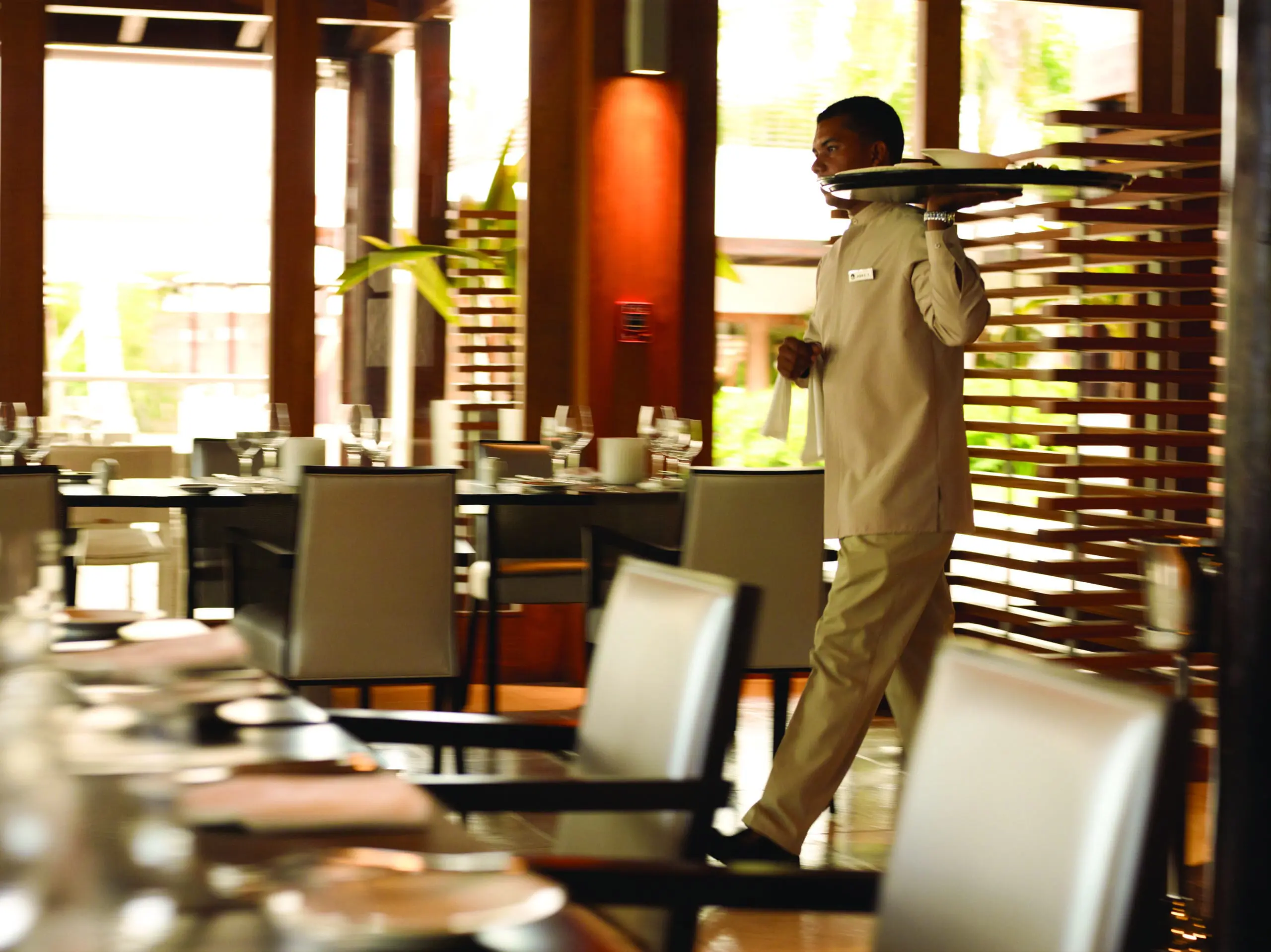 A waiter serving guests at La Caña Bar &amp; Restaurant