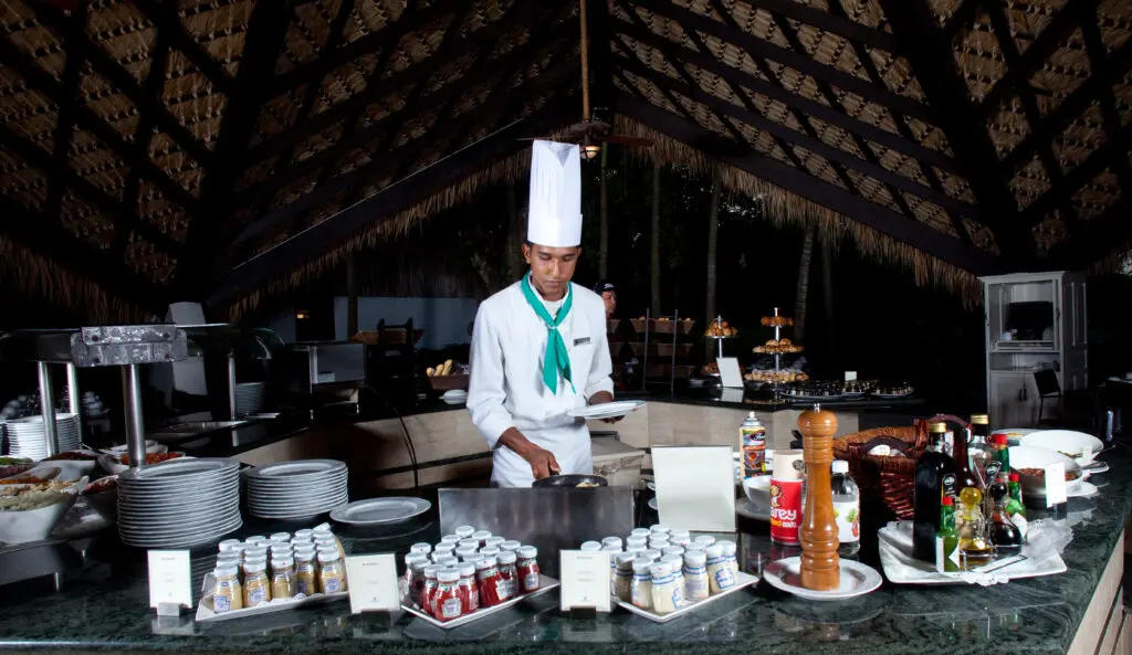 A chef preparing a meal at Lago Restaurant in the Dominican Republic