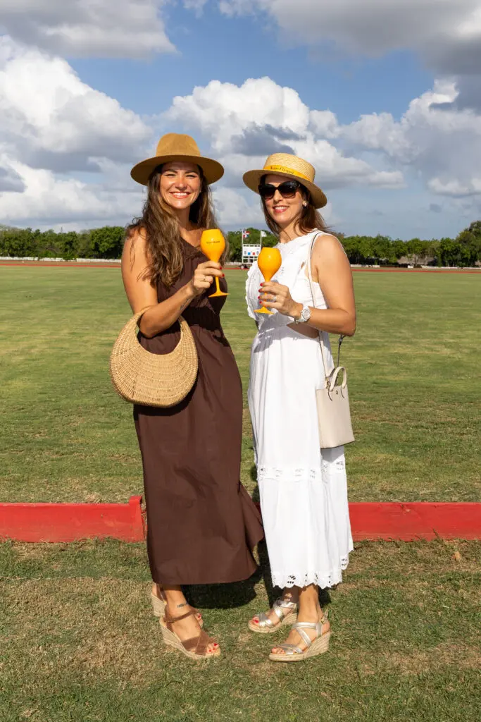 Estee Princen and Emilie Teuma pose with a drink at a La Romana sports event