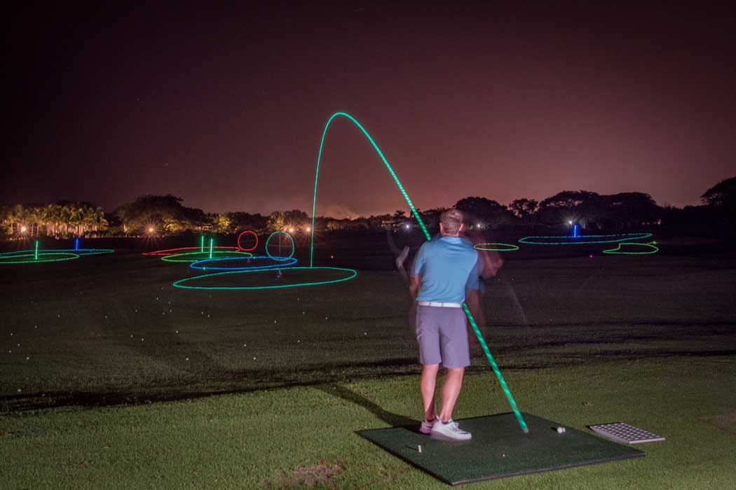 Multi-color LED golf balls fill the night sky at our Night Golf party