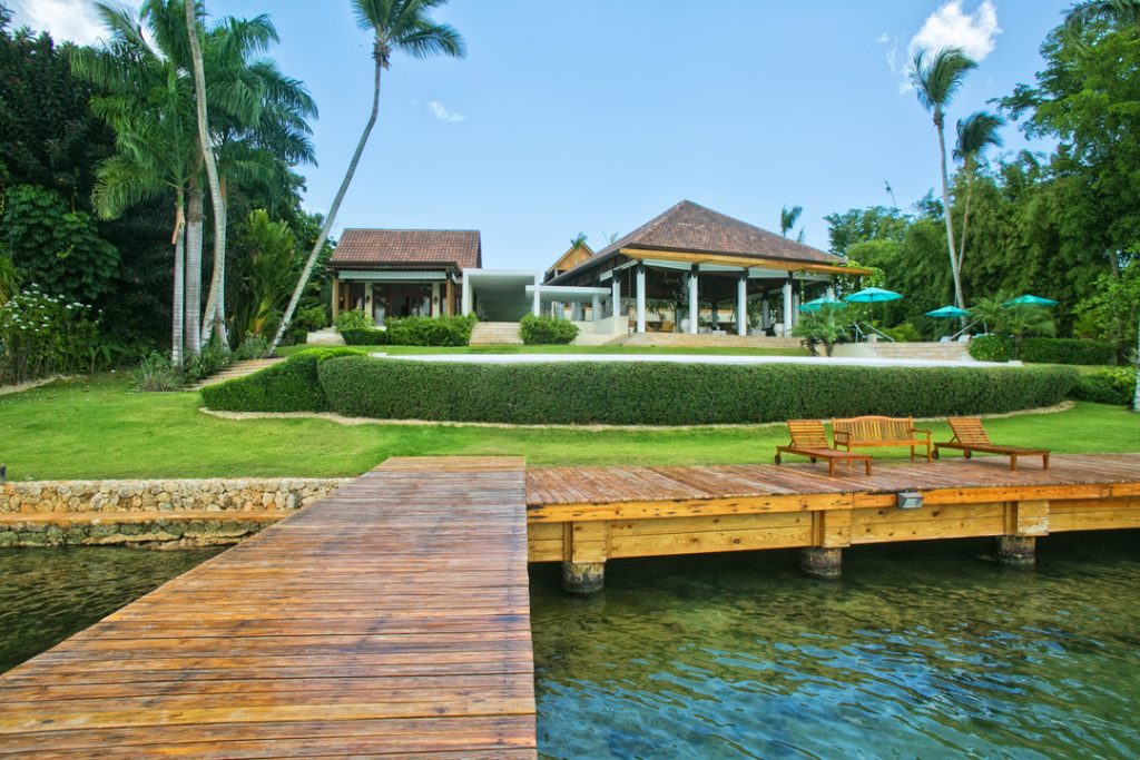 Casa de Campo Villa Exterior With Boardwalk, Pool, and Lounge Area