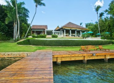 Casa de Campo Villa Exterior With Boardwalk, Pool, and Lounge Area