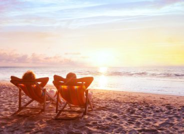 Couple in the beach enjoying sunset