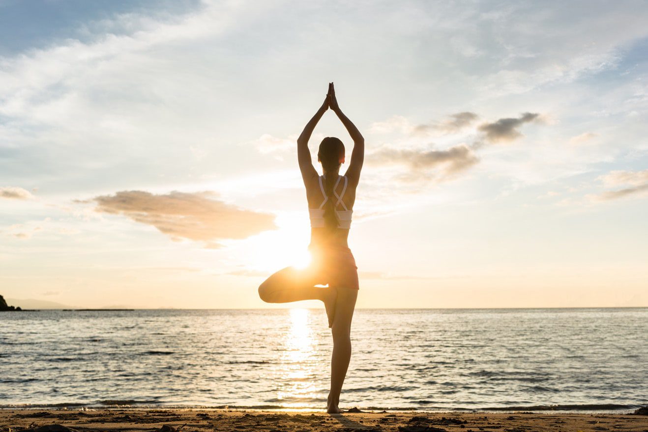 Yoga stance on the beach during sunset
