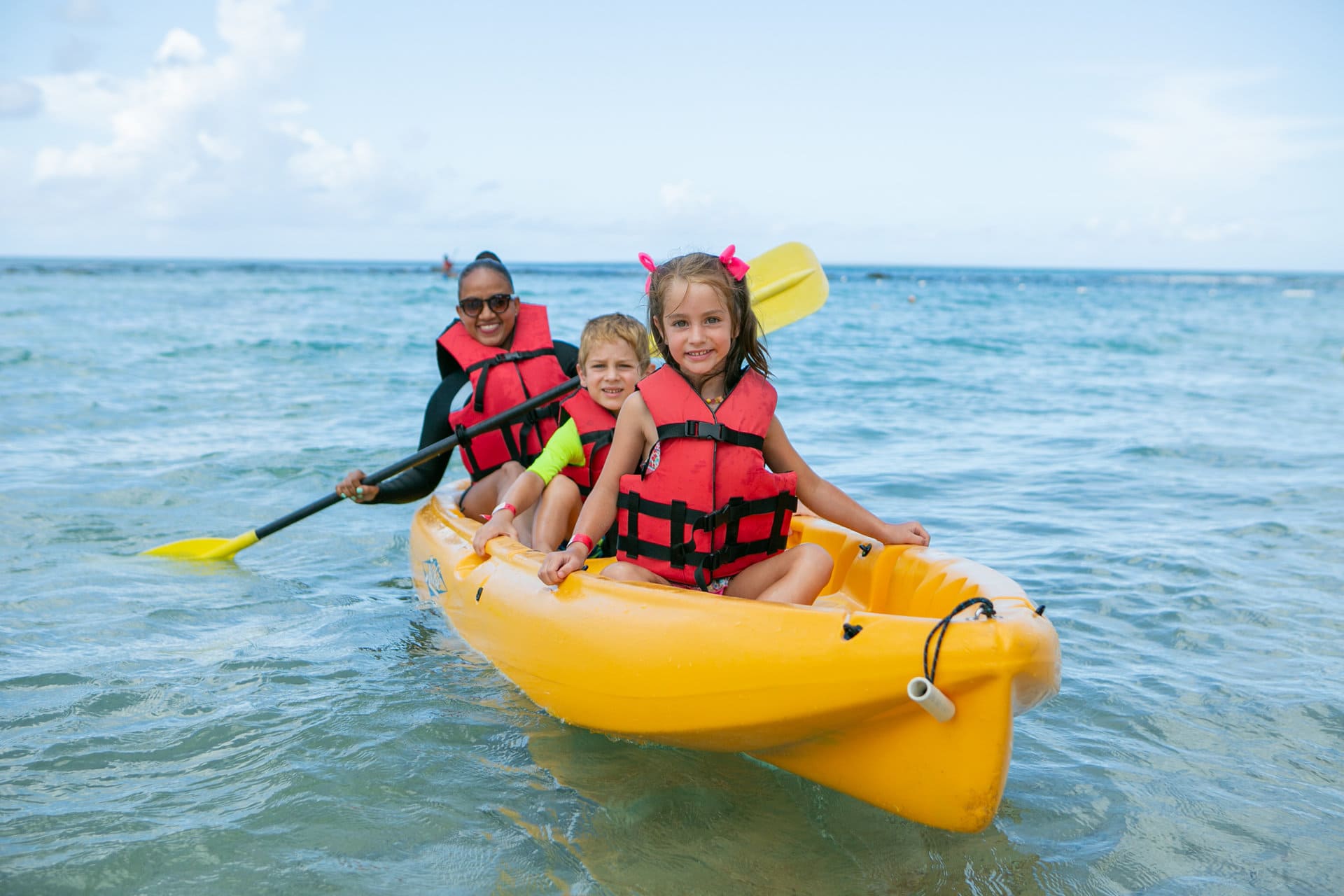 Kids kayak in Minitas Beach Casa de Campo